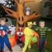 Kids dressed as Captain America, red Power Ranger, Pikachu and The Hulk stand in front of inflatable Halloween tree and inflatable jack-o-lanterns